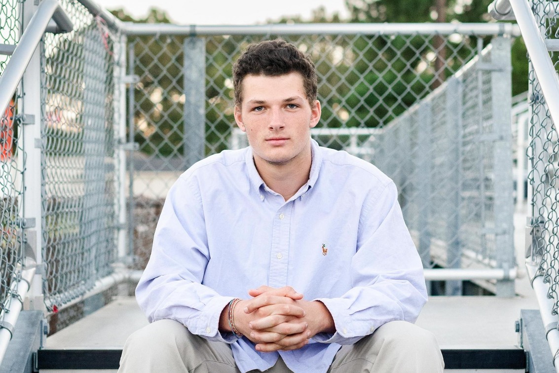 Oahu Male Senior Photographer | Male senior sitting on bleachers