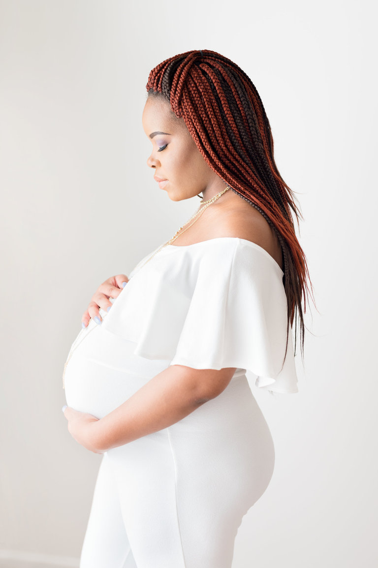 Oahu Maternity Photography | Studio Photo of a pregnant woman holding her belly