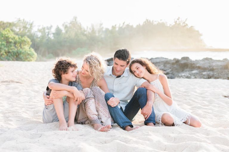 Honolulu Family Photographer | Best Oahu Family Photographer | family sitting on beach hugging at Turtle Bay