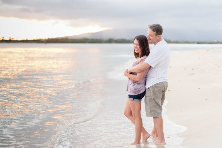 Oahu Couples Photographers | Honolulu Couples Photographer | Husband and wife hugging on Hawaii beach at sunset