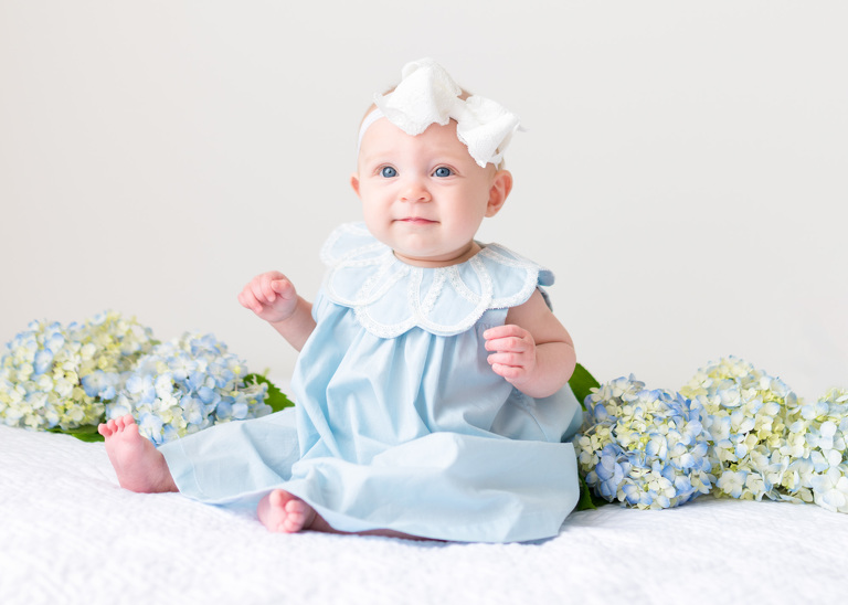 Best Honolulu Baby Photographer | Oahu Family Photographer | Six month old baby girl with flowers in background