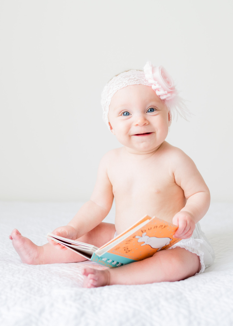 Best Baby Photographers Oahu Family Photographer | Portrait of six month old girl holding Pat the Bunny book