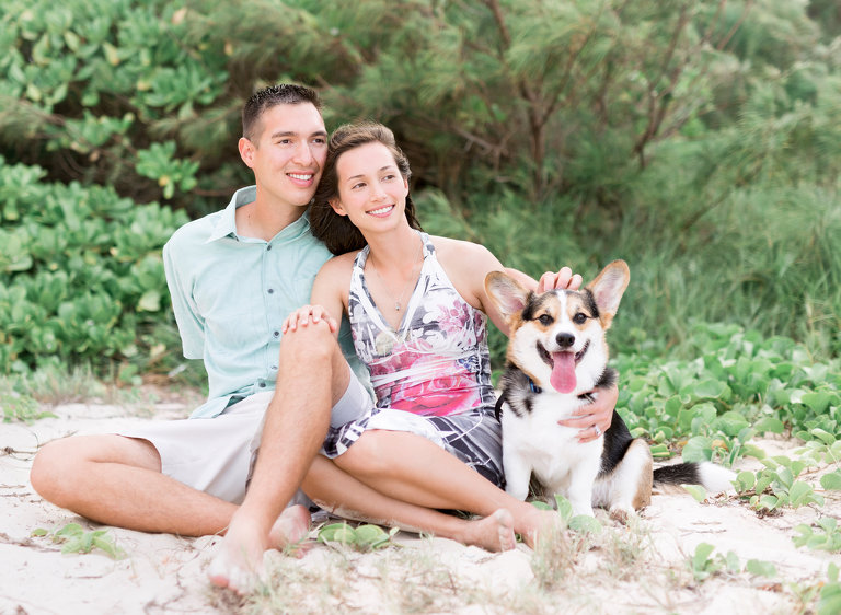 Best Oahu Photographer | Honeymoon Couple sitting on beach with Corkie dog