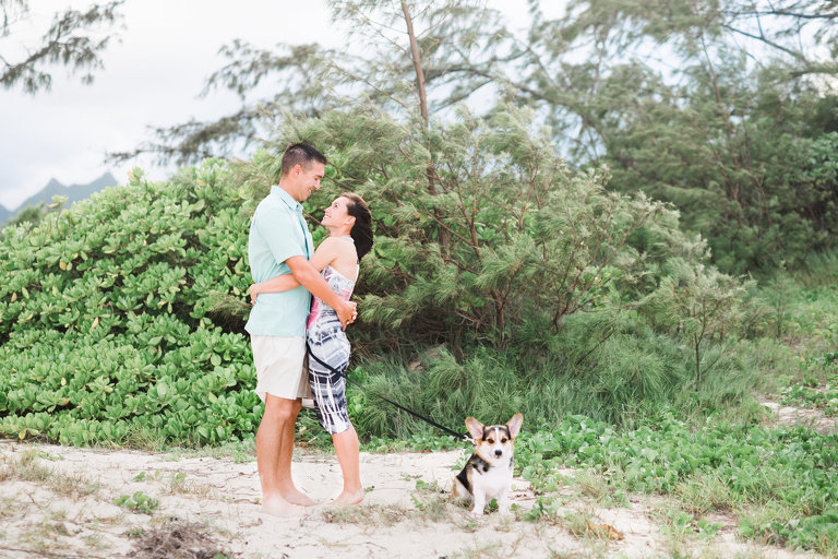 Best Oahu Photographers for Couples | Couple hugging on Hawaii beach with dog