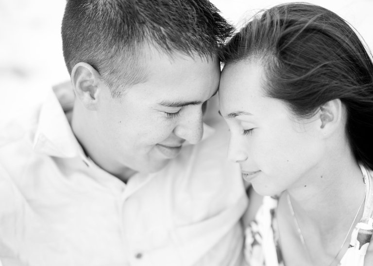 Oahu Photographer for Couples | black and white image of couple caressing on beach